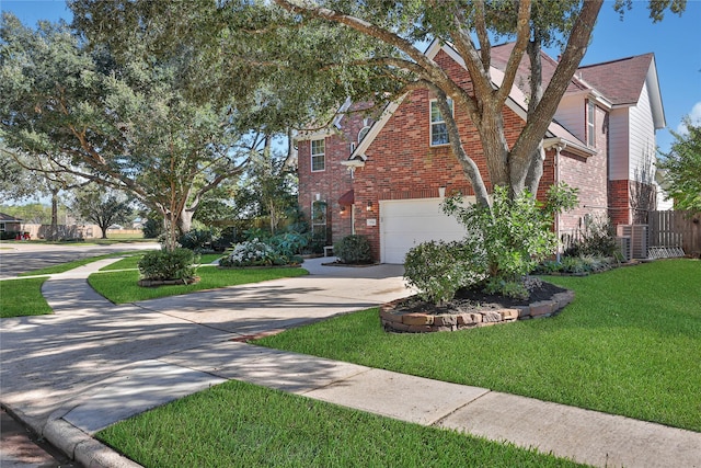 view of front of property featuring a garage, central AC, and a front yard