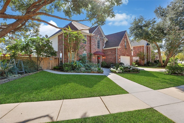 view of front of house with a garage and a front lawn