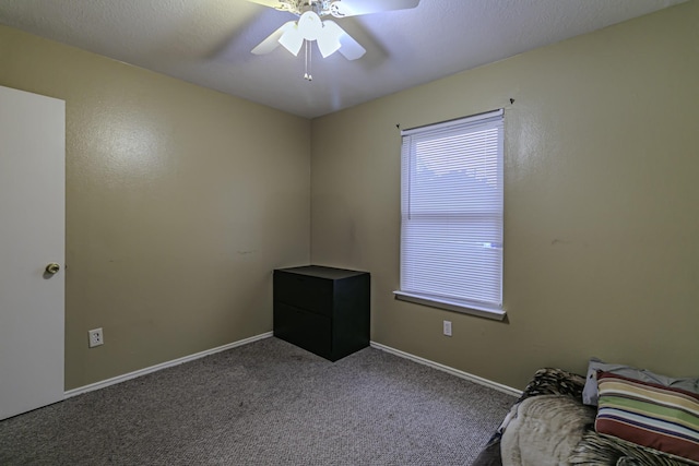 unfurnished room featuring ceiling fan and carpet