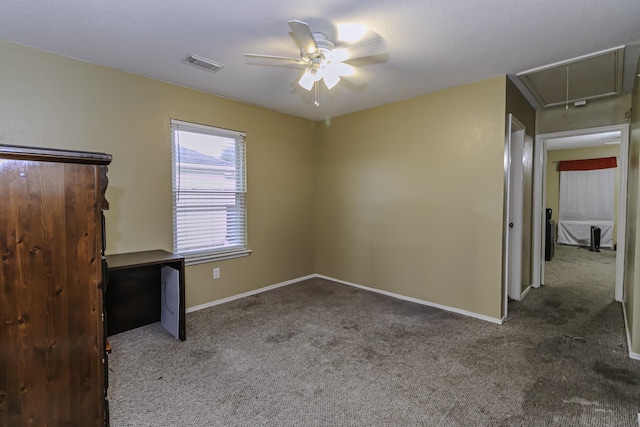 interior space featuring ceiling fan and dark colored carpet