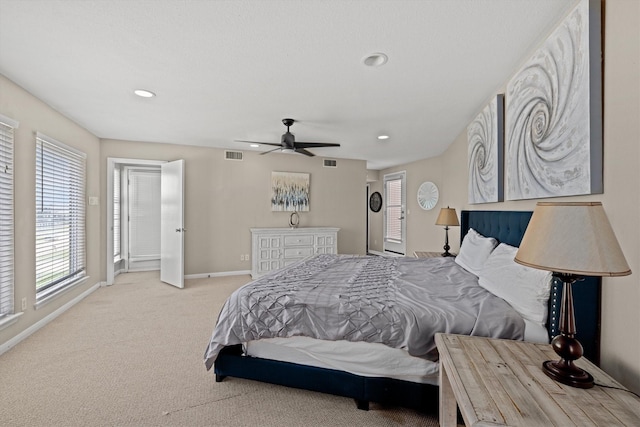 bedroom with ceiling fan and light colored carpet