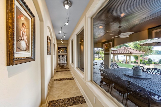 corridor featuring light tile patterned floors