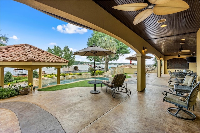 view of patio / terrace featuring pool water feature and ceiling fan