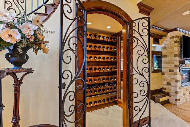 wine room featuring tile patterned floors and crown molding