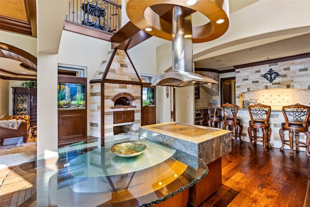 dining space featuring a fireplace, dark hardwood / wood-style flooring, and a tray ceiling