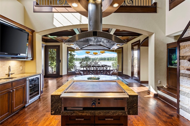 interior space featuring wet bar, wine cooler, and dark wood-type flooring