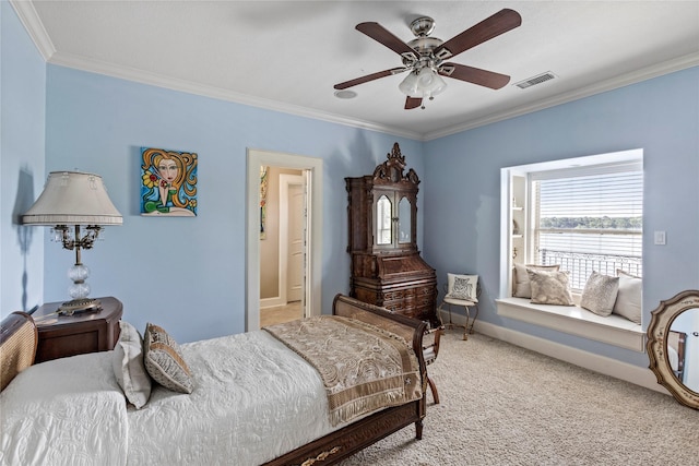 carpeted bedroom with ceiling fan and crown molding