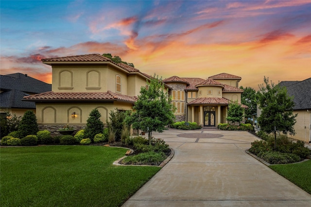 19996 Crescent Ct, Montgomery, TX 77356 - mediterranean / spanish home featuring french doors, a lawn, curved driveway, stone siding, and stucco siding