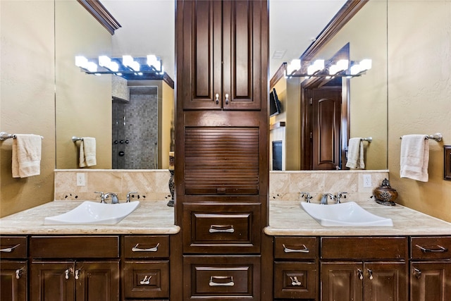 bathroom with vanity, walk in shower, ornamental molding, and tasteful backsplash