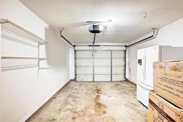 garage with a garage door opener and white fridge with ice dispenser