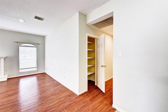 interior space with hardwood / wood-style floors and a textured ceiling