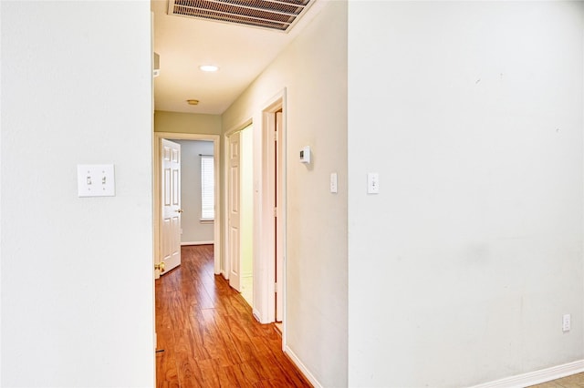 hallway with hardwood / wood-style floors