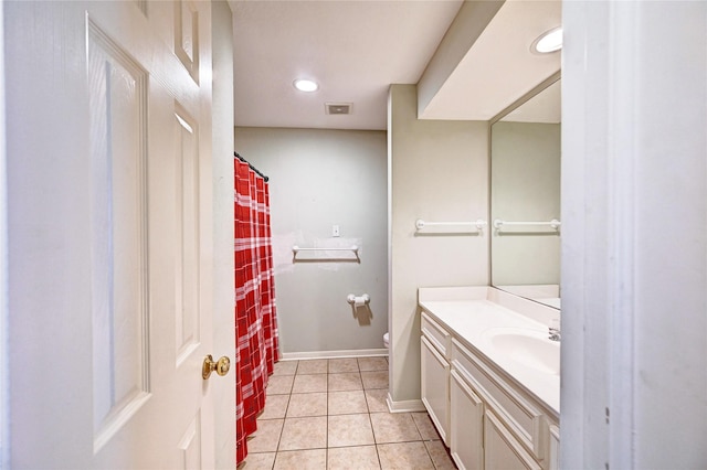 bathroom with toilet, tile patterned floors, and vanity