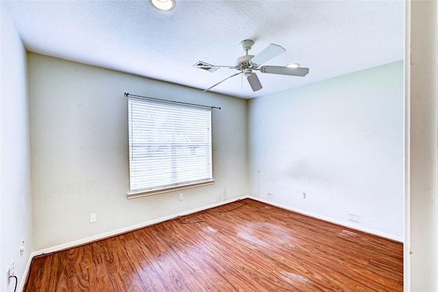 unfurnished room with hardwood / wood-style flooring and ceiling fan