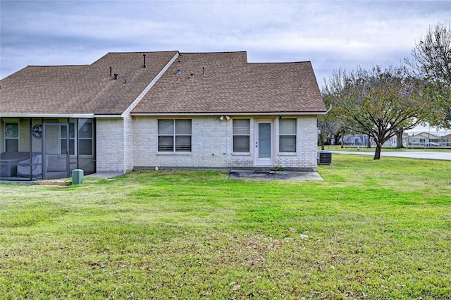 back of house featuring cooling unit and a lawn