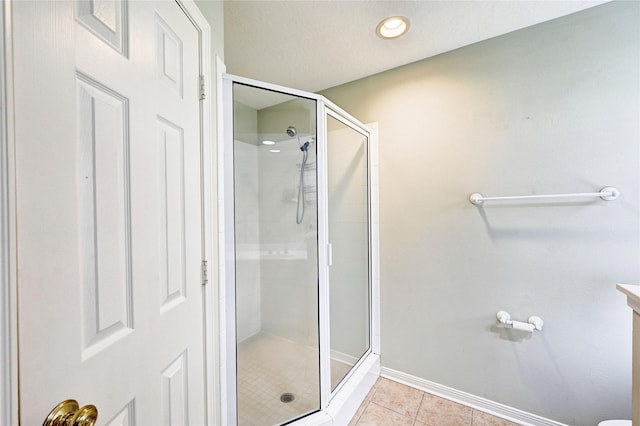 bathroom featuring an enclosed shower, vanity, and tile patterned flooring