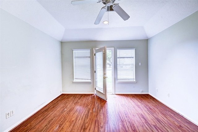 unfurnished room featuring wood-type flooring, a textured ceiling, vaulted ceiling, and ceiling fan