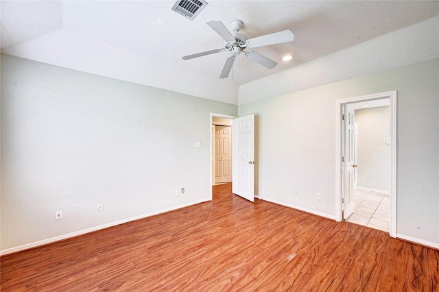 spare room featuring ceiling fan and light hardwood / wood-style flooring