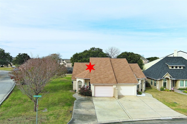 view of front of property with a garage and a front yard