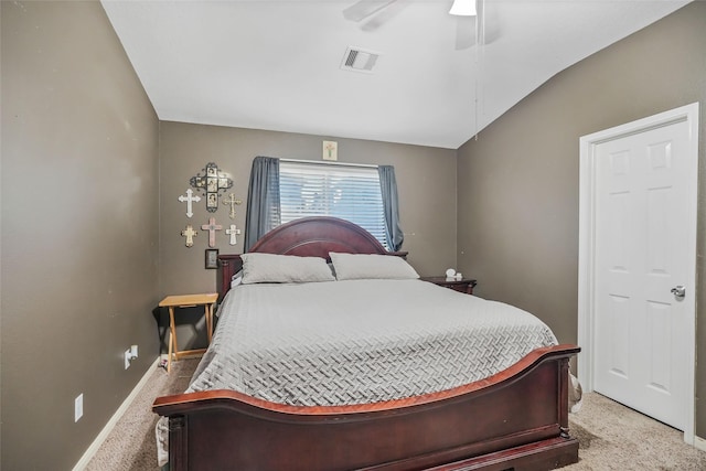 bedroom featuring ceiling fan, light carpet, and vaulted ceiling