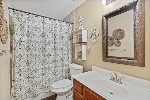 bathroom with a textured ceiling, toilet, and vanity