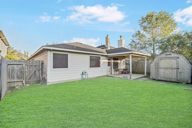 rear view of property with a storage unit, a patio, and a lawn