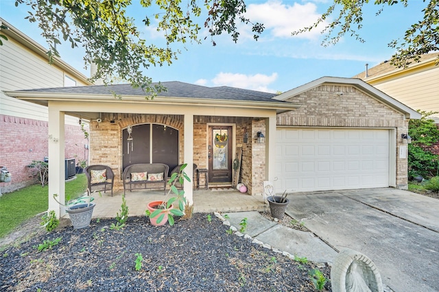 ranch-style house featuring covered porch and a garage