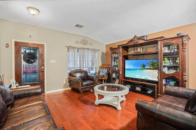 living room featuring hardwood / wood-style flooring and lofted ceiling