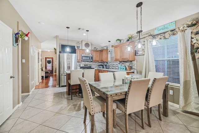 tiled dining area featuring lofted ceiling