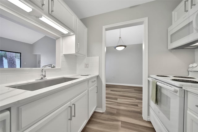 kitchen with sink, white cabinetry, light stone countertops, white appliances, and light hardwood / wood-style floors