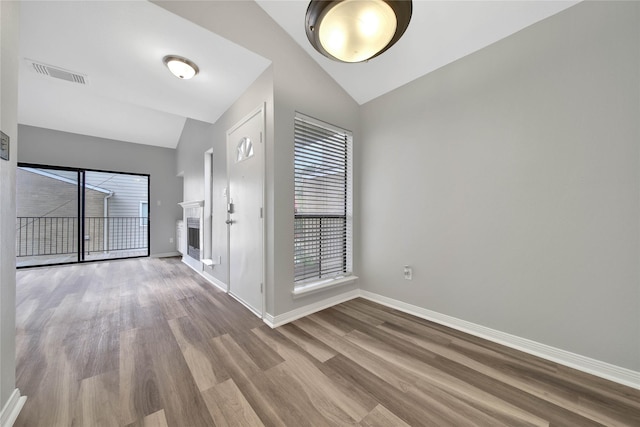 foyer entrance with vaulted ceiling and light hardwood / wood-style flooring