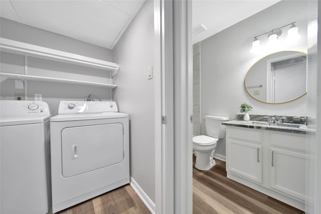 laundry area with sink, dark hardwood / wood-style flooring, and separate washer and dryer