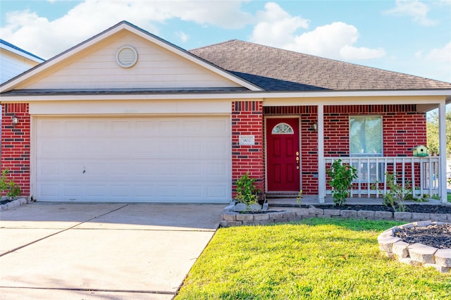 view of front of property with a garage, a front yard, and covered porch