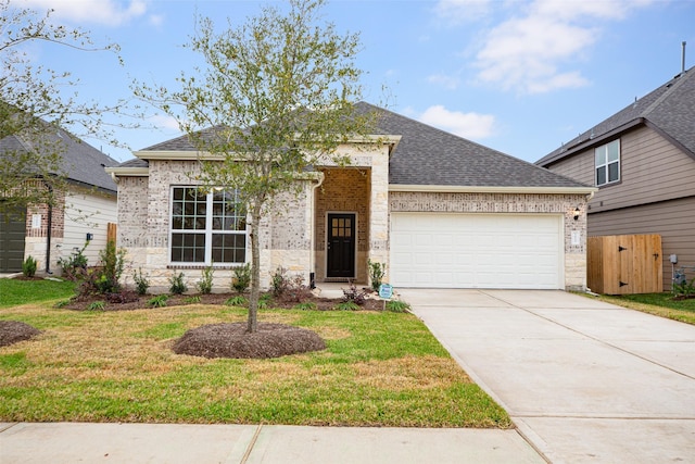 view of front of house with a front yard and a garage