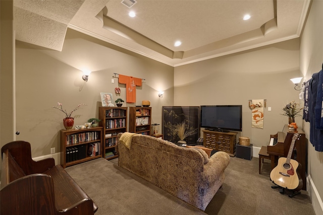 living room with crown molding, carpet floors, and a raised ceiling