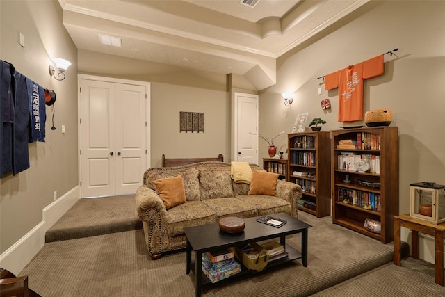 living room with carpet floors and a tray ceiling