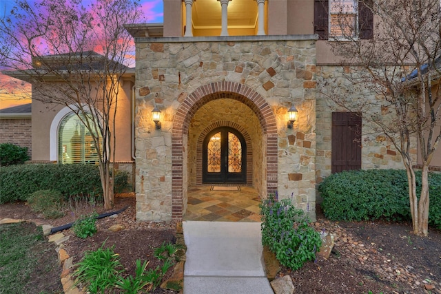 exterior entry at dusk with french doors