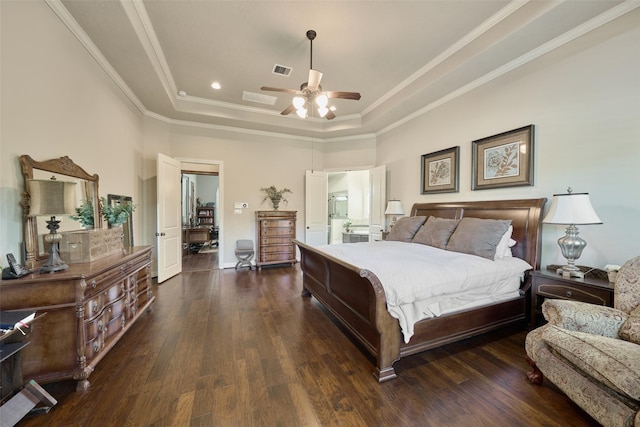 bedroom with ornamental molding, dark hardwood / wood-style flooring, and a raised ceiling