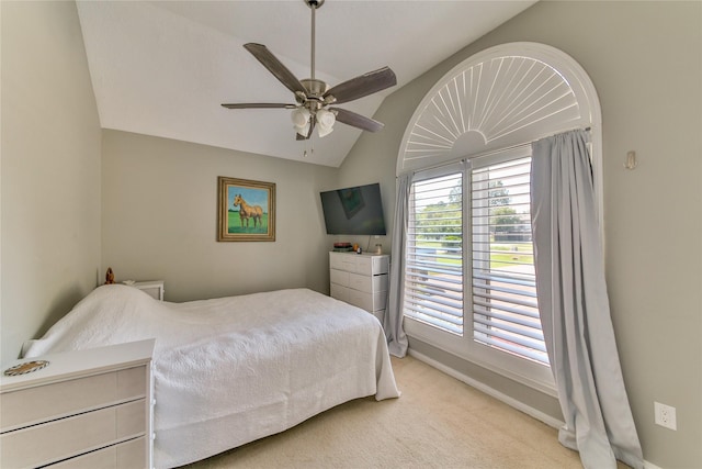 bedroom featuring vaulted ceiling, light colored carpet, and ceiling fan