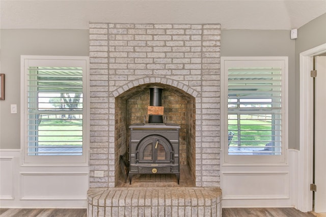 room details with a wood stove and hardwood / wood-style floors