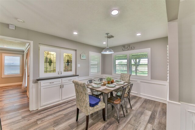 dining room featuring a healthy amount of sunlight and hardwood / wood-style floors