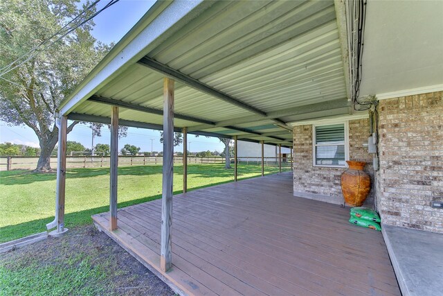 wooden deck featuring a lawn