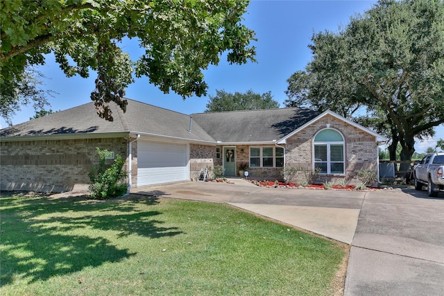 ranch-style home with an attached garage, a front lawn, concrete driveway, and brick siding