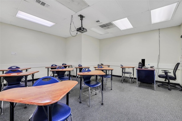 interior space featuring a drop ceiling and carpet flooring