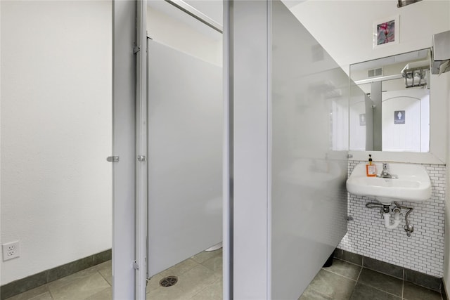 bathroom with sink and tile patterned flooring