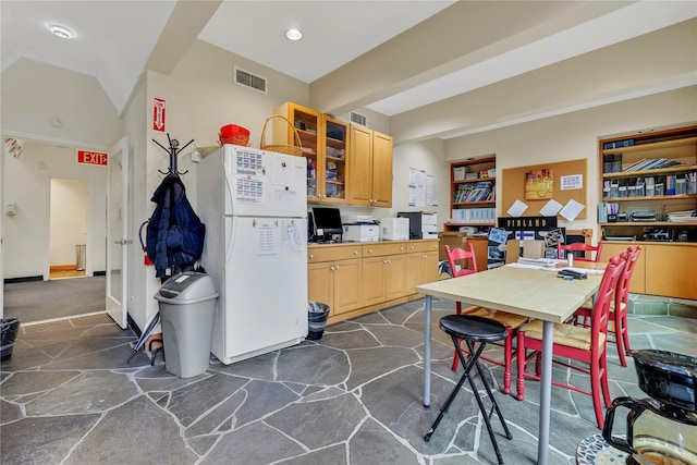 kitchen with white fridge and light brown cabinets