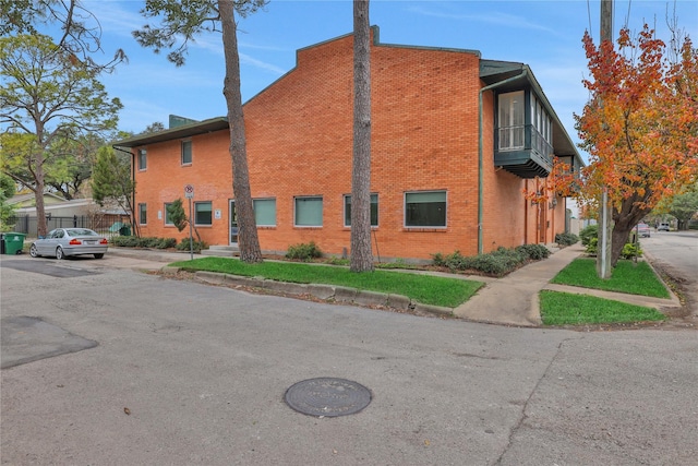 view of side of property with a balcony