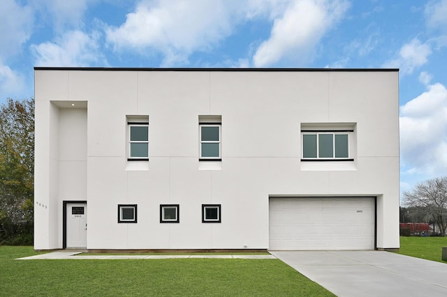 modern home featuring a garage and a front yard