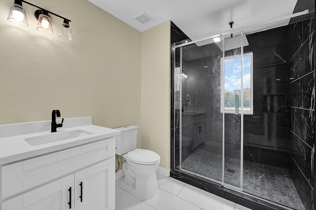 bathroom featuring walk in shower, tile patterned floors, toilet, and vanity