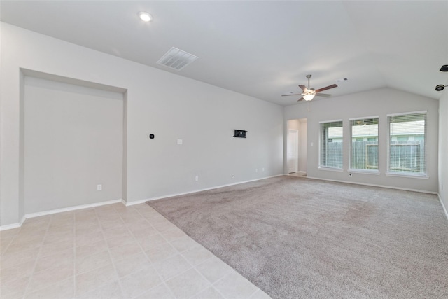 carpeted spare room with ceiling fan and lofted ceiling